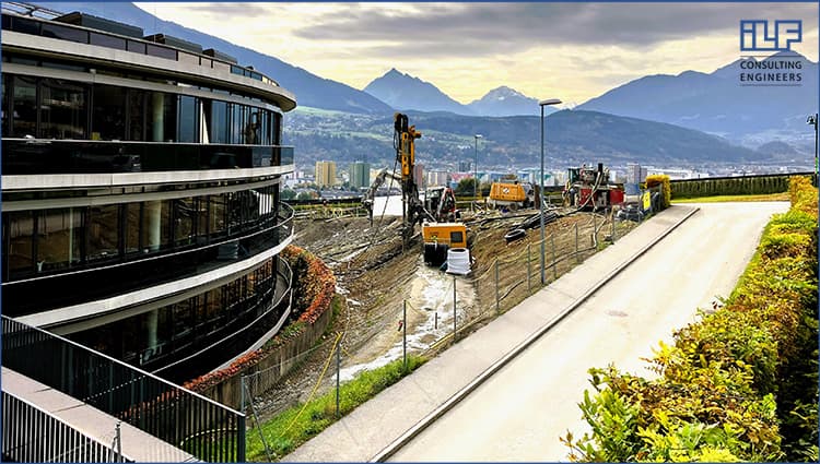 Construction site next to the ILF Consulting Engineers office in Rum, Austria, with mountains in the background.