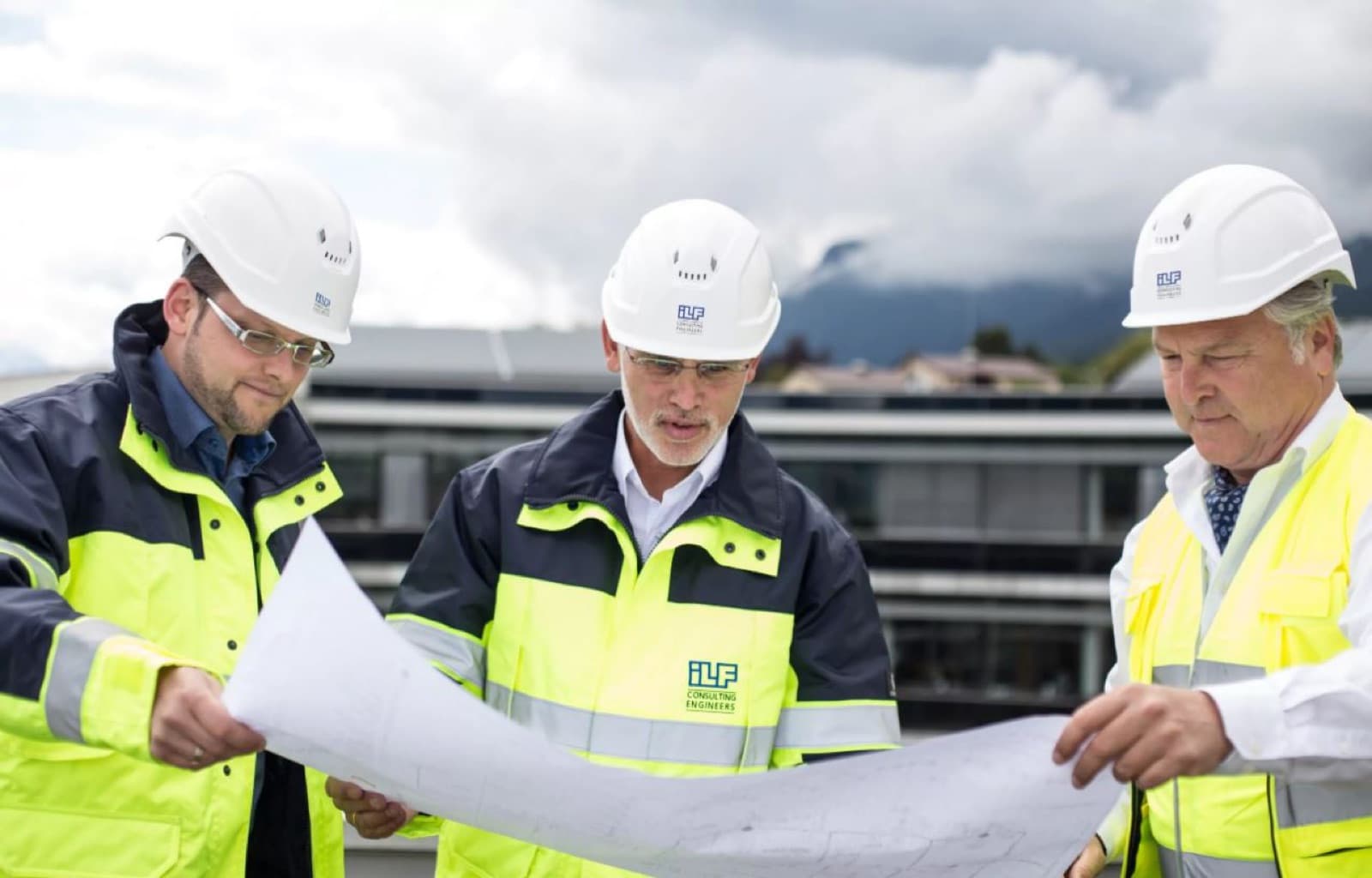Three ILF engineers reviewing plans